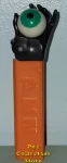 (image for) Black Psychedelic Hand holding Green Eye Pez on Orange Stem